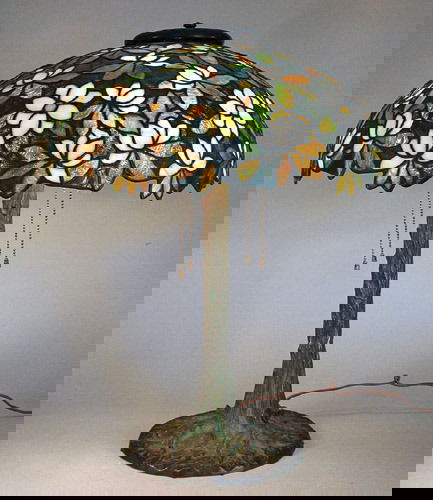 Riviere Studios Floral Leaded Glass Lamp: Rare Riviere Studios overall floral leaded glass lamp. Riviere lamps are not seen very often. This is an original package with a 21" diameter overall floral shade. The backround is a fiery blue/green