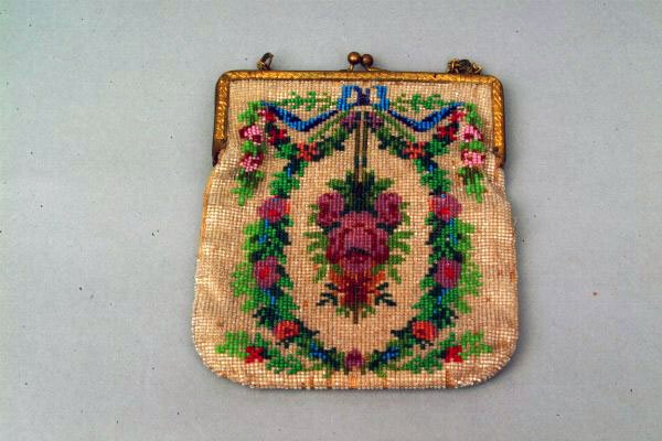 Vintage Beaded Handbag: Vintage Beaded Handbag With a brass frame cast with a reed and ribbon motif, the bag applied with multicolored beads with a floral bouquet enclosed within a wreath bound by a ribbon, lined in a suede