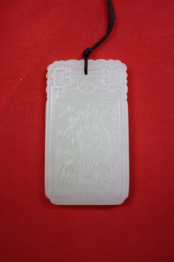 Chinese White Jade Pendant: Chinese white jade pendant carved a big fish with a boy on top and calligraphy at the back. H 2" x W 1.1"