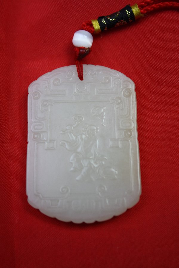 Chinese White Jade Pendant: Chinese white jade pendant carved figure with calligraphy at the back. H 2.1" x W 1.3".