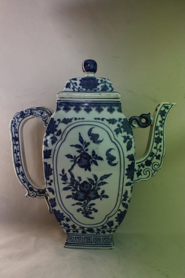 Chinese Blue and White Porcelain Teapot: A Chinese blue and white porcelain teapot, decorate with fruit, floral and bats. Qianlong mark. Circa 19-20 century. H 10" x W 9".