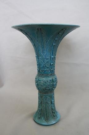 Chinese Turquoise-glazed porcelain Beaker Vase: A Chinese turquoise-glazed carved porcelain beaker vase, incised Qianlong mark. Circa 19-20 century. H 11" x W 7".