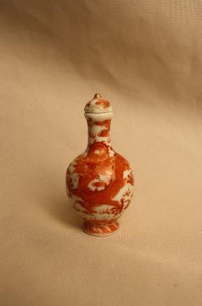 Chinese Copper-red Porcelain Snuff Bottle: A Chinese dragon copper-red porcelain snuff bottle. Qianlong mark. H 3" x W 1.4".