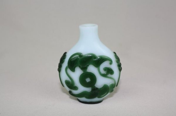 Chinese Green Overlay White Glass Snuff Bottle: A Chinese green overlay white glass snuff bottle, decorated with bats. 3" x 1.6".