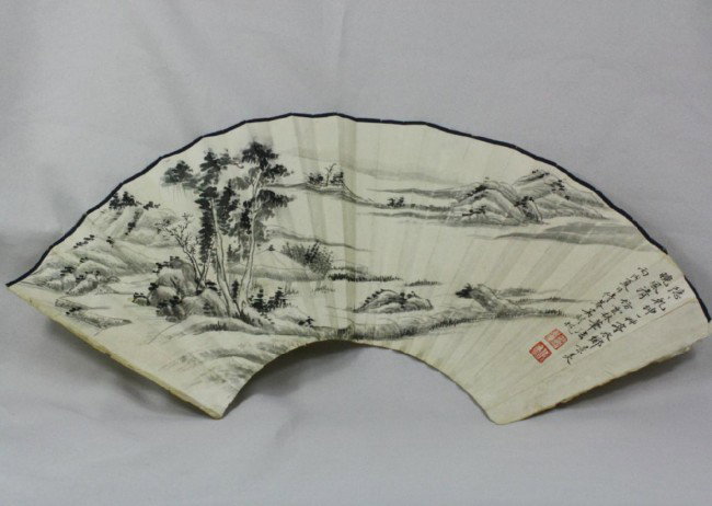 Chinese Fan Painting: Chinese fan painting, ink and color on paper, 20th century, depicting a misty mountain landscape with tall wooded peaks, the top with a colophon followed by a cyclical date and signature, with one sea