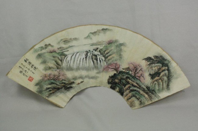 Chinese Fan Painting: Chinese fan painting, ink and color on paper, 20th century, depicting a misty mountain landscape with water fall, the top with a colophon followed by a cyclical date and signature, with one seal; the 