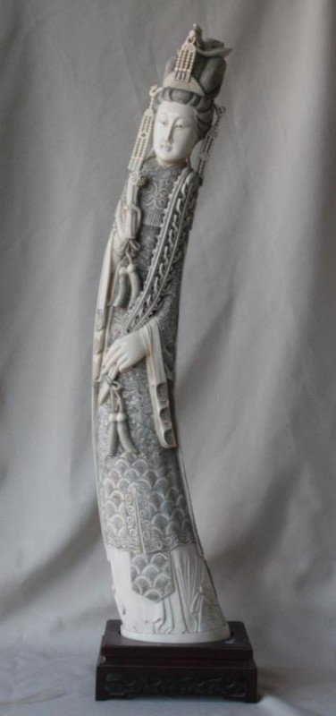 Chinese Carved Ivory Figure of a Female Deity: Large and Impressive Chinese Carved Ivory Figure of a Female Deity, 20th century, carved in high relief following the curve of the tusk as a female deity holding a Ruyi Scepter, the figure clad in oce