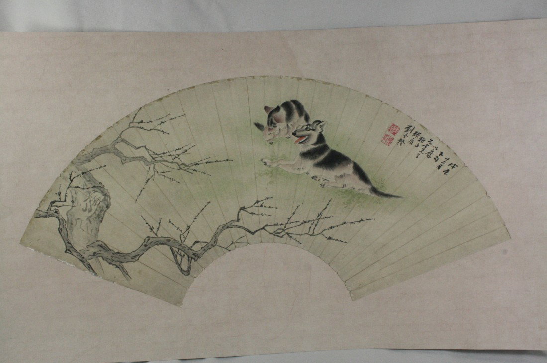 Chinese Fan Painting: Chinese fan shape painting, ink and color on paper, 20th century, portraying three dogs, the top right with a short colophon and signature, with two seal. 9" x 21".