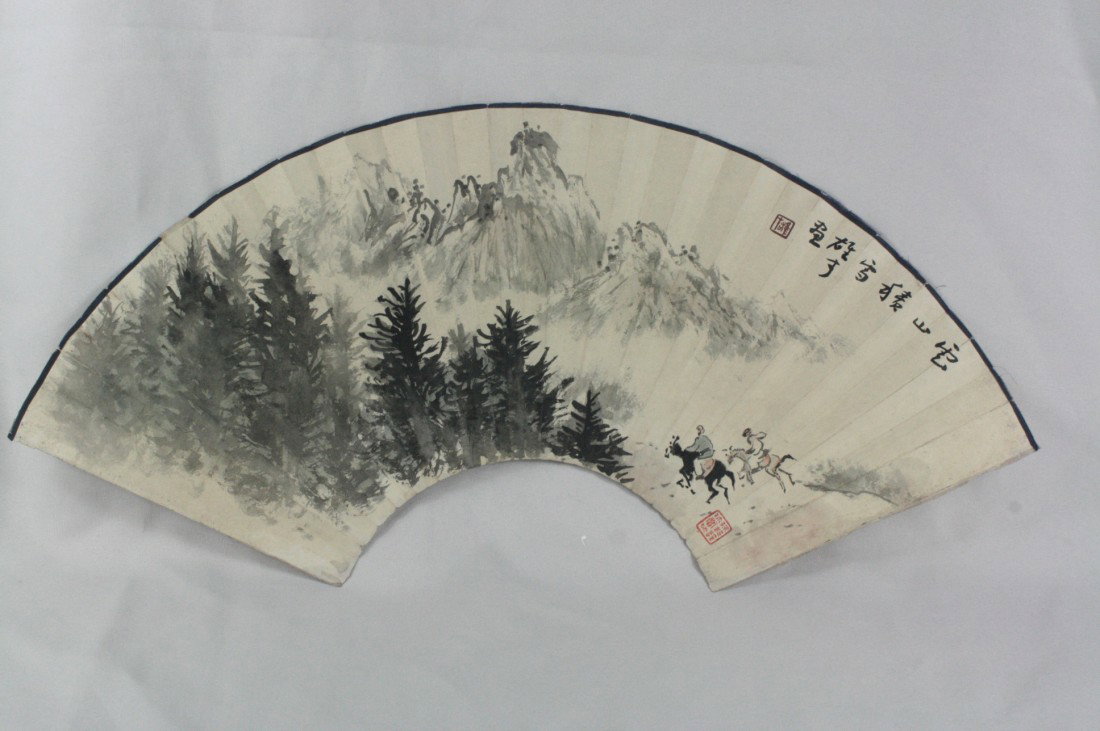 Chinese Fan Painting: Chinese fan painting, ink and color on paper, 20th century, featuring a majestic mountain landscape with two figures Riding a horse thru a misty valley, right top with a short colophon with a cyclical