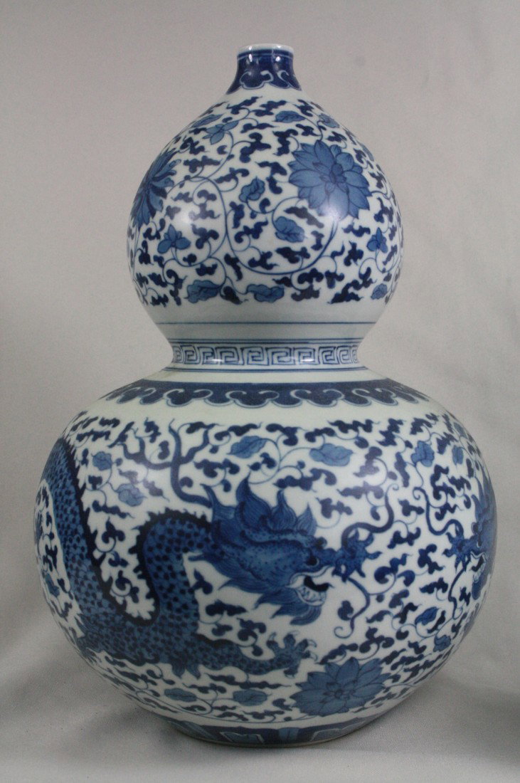 Chinese Double Gourd Porcelain Vase: Chinese double Gourd porcelain vase, finely painted in blue and white with dragon and floral, keyfret band separating the two gourds. Yongzheng mark. 12" x 7".