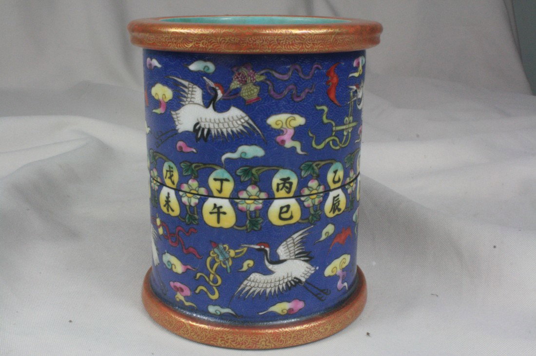 Chinese Polychrome Enamel Porcelain Brush Pot: Chinese polychrome enamel porcelain brush pot that can be rotated, Painted in brightly hued enamels with crane and bats, all reserved on a blue ground with a dense floral pattern, the base bearing an 