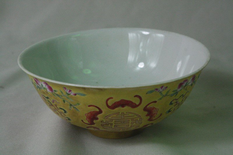 Chinese Famille Rose Porclain Bowl: Chinese famille rose porclain Bowl, finely painted in brilliantly colored enamels with stylized floral and bats, on a yellow ground. Guangxu mark. 2.4" x 5.2".