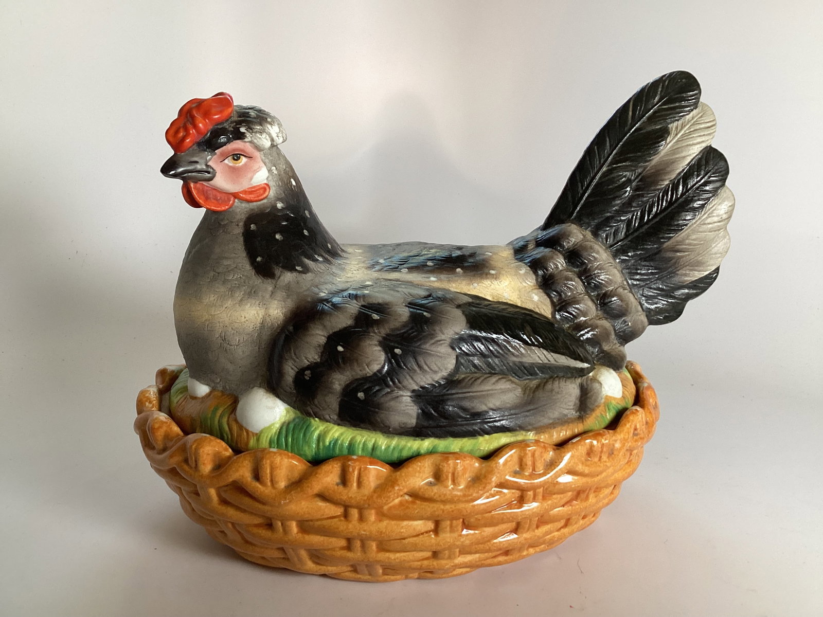 Large English Staffordshire Hen on Nest: Excellent condition with minor edgewear. Polychrome decorated bisque glaze lid over brown glazed basket. 10.5" wide and 8.5" tall.