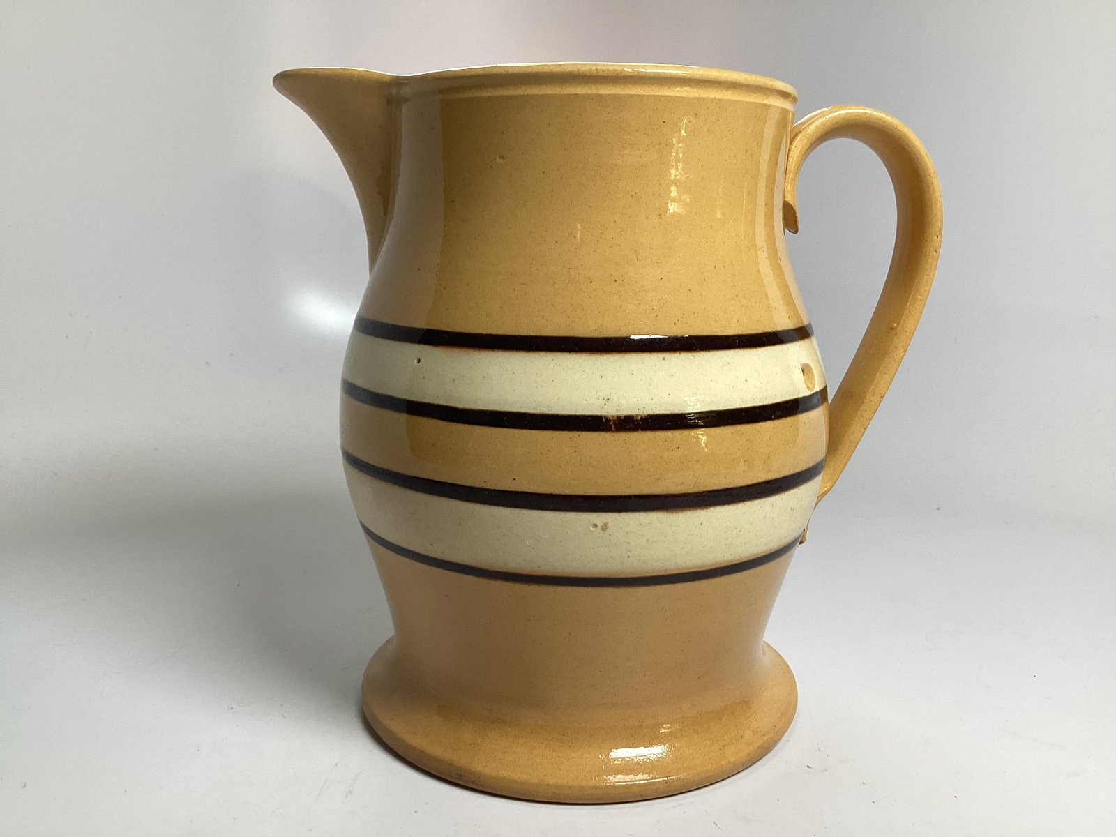 English Yelloware Banded 7.5" Jug: Excellent condition including two original shallow chips under factory glaze.
