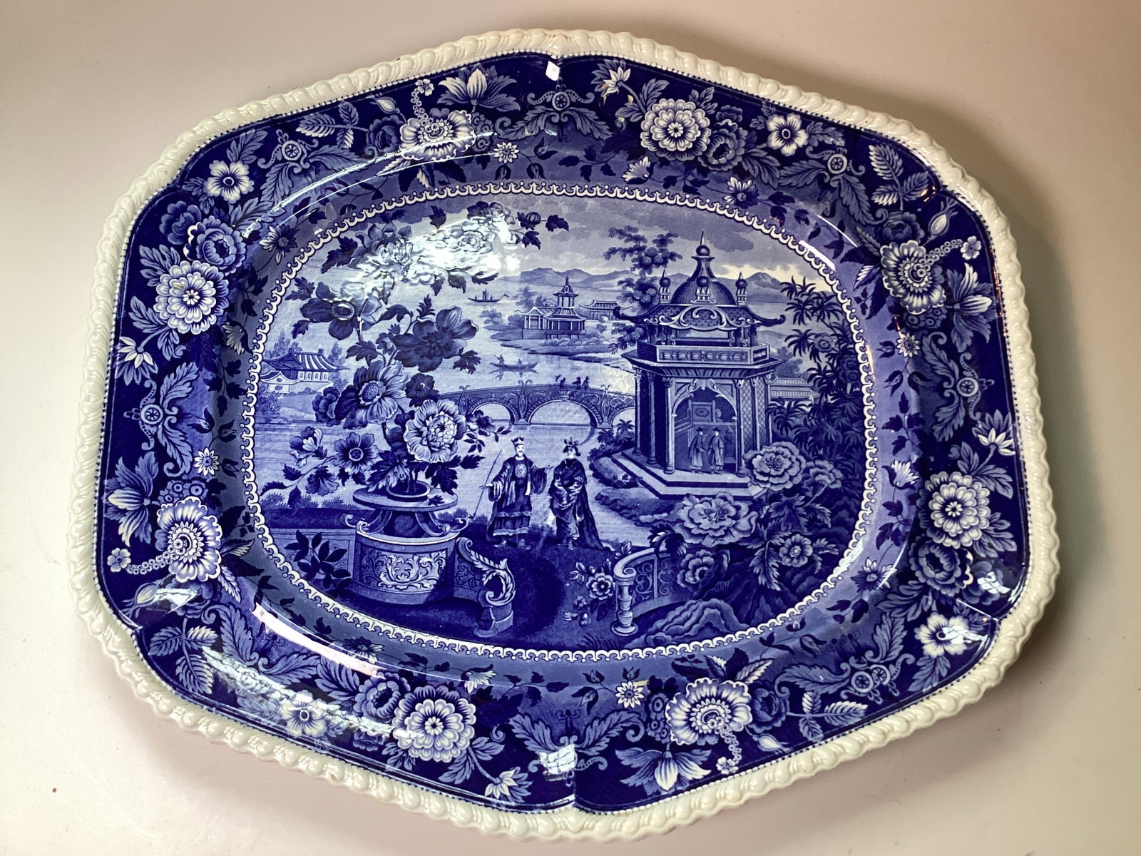 Large Ridgway Dark Blue Staffordshire Platter ASIATIC PALACES: 19" wide. A fine and large example with a gadrooned edge around a floral band centering a romantic Asian landscape with figures. Excellent condition with a pearlized finish.