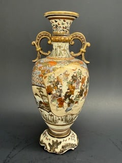Japanese Taisho Period Satsuma handled 7 1/4" vase: This vase packs a lot into its small size. Butterflies, flowers, geometric patterns, figures, landscapes, more flowers, one panel depicting all boys and another panel depicting all girls. This vase se