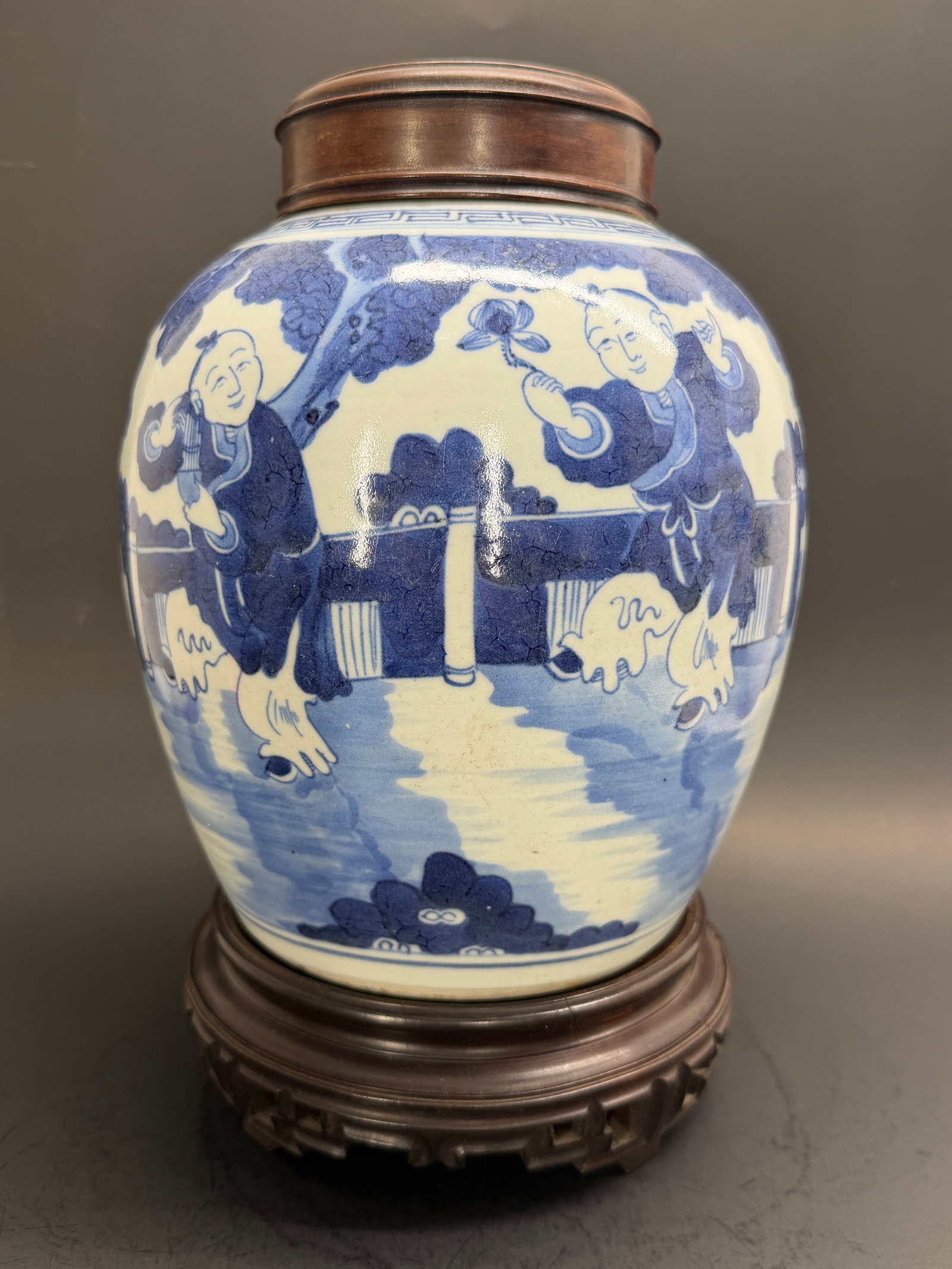 Chinese Qing Dynasty blue and white 11" Baluster jar featuring the heehee Twins with period Stand an: This fantastic jar will grab your attention from across the room! Featuring the playful Hee-Hee twins on one side and a sprig of leaves on the reverse. Includes period carved wood lid and stand. 