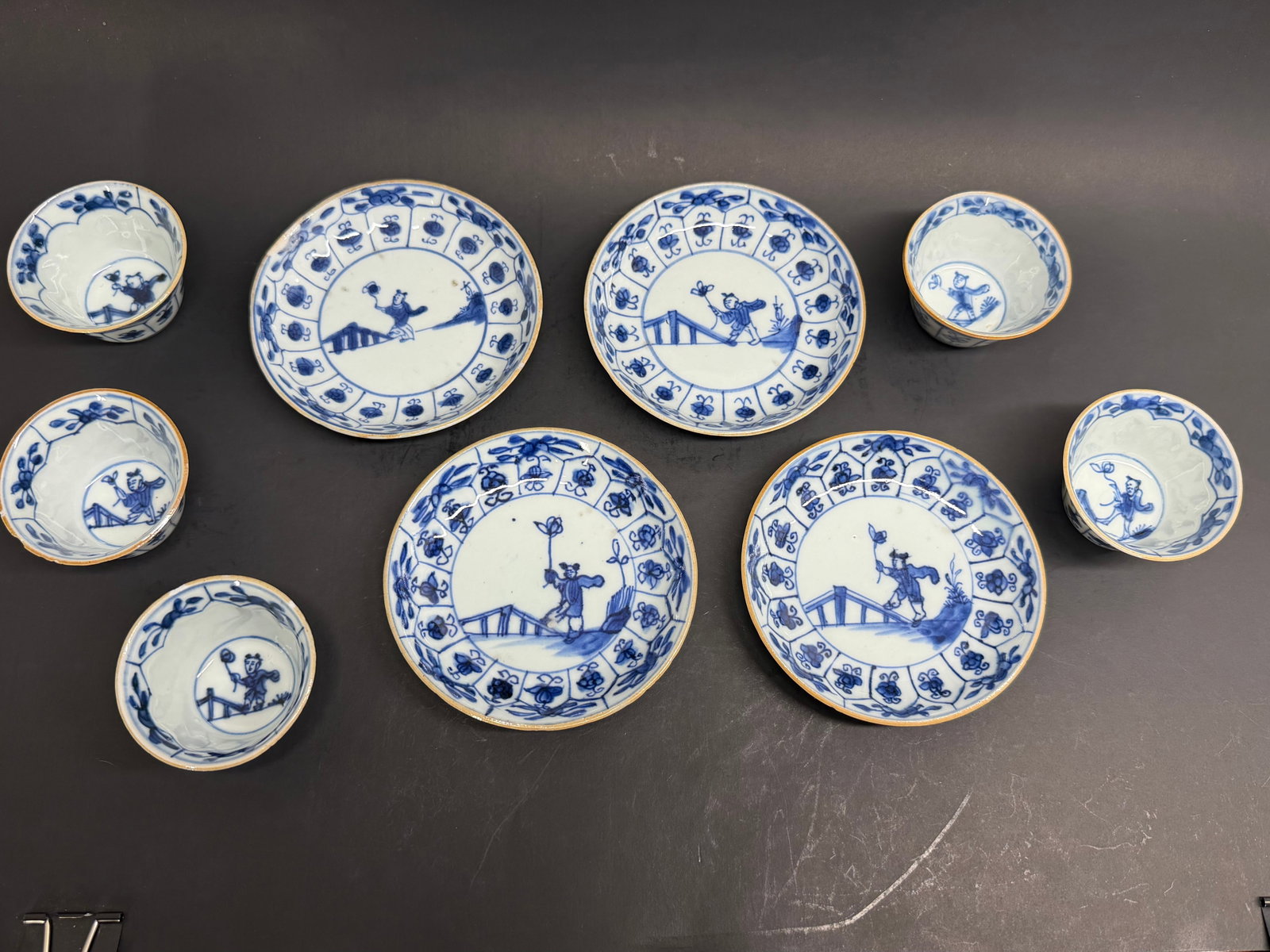 Chinese Export Kangxi Porcelain Lot of matched cups and saucers for a tea set. Early 18th Century: This lot consists of 9 pieces that are perfectly matched. 5 cups and 4 saucers. Saucers are 3/4 of an inch tall by 4 1/4 inches in diameter. The cups are 1 1/2 inches tall by 2 1/2 inches in diamete