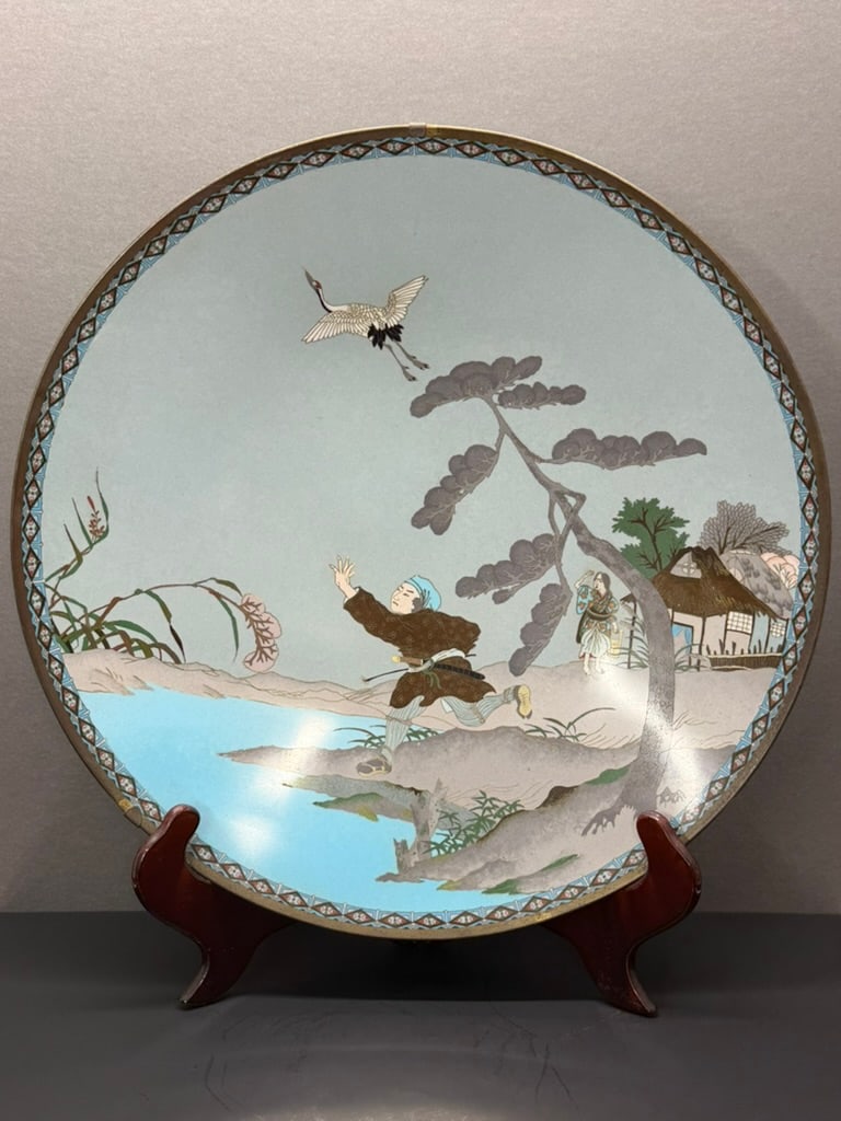 Japanese Meiji Period Cloisonne charger featuring the story of the crane wife. Tsuru no Ongaeshi: Large and Rare 17 7/8" Japanese Meiji Period Cloisonne charger featuring the story of the crane wife. Tsuru no Ongaeshi. 17 7/8ths inches across