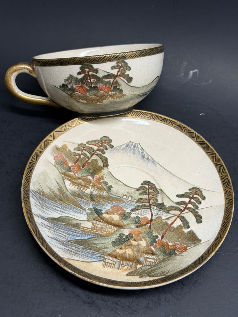 Japanese Meiji Period Satsuma Tea Cup and Saucer Signed Ryuzan: Japanese Meiji Period Satsuma Tea Cup and Saucer Signed Ryuzan. Beautiful landscape and village scene. Saucer is 5 1/2'' cup is 3 5/8ths by 1 5/8" deep.