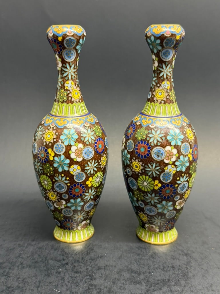 Pair of Chinese 20th Century 5 1/2" Garlic Head Cloisonne Vases: Pair of Chinese 20th Century 5 1/2" Garlic Head Cloisonne Vases decorated with a large assortment of flowers and a Ruyi border. 5 1/2'' by 2" wide.