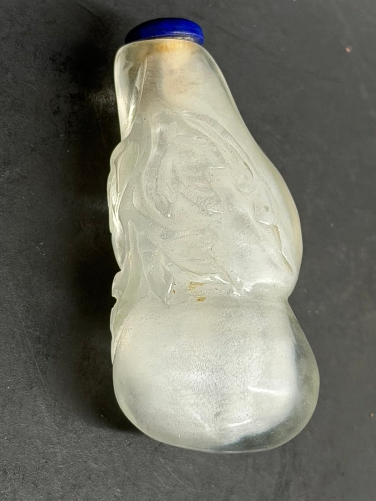 Late 19th - Early 20th Century Chinese Carved Rock Crystal Double Gourd Snuff Bottle: Late 19th - Early 20th Century Chinese Carved Rock Crystal Snuff Bottle in the Form of a Double Gourd with Vines and Leaves with a Lapis Stopper. 2 5/8" long by 1 1/8" by 1 1/4"