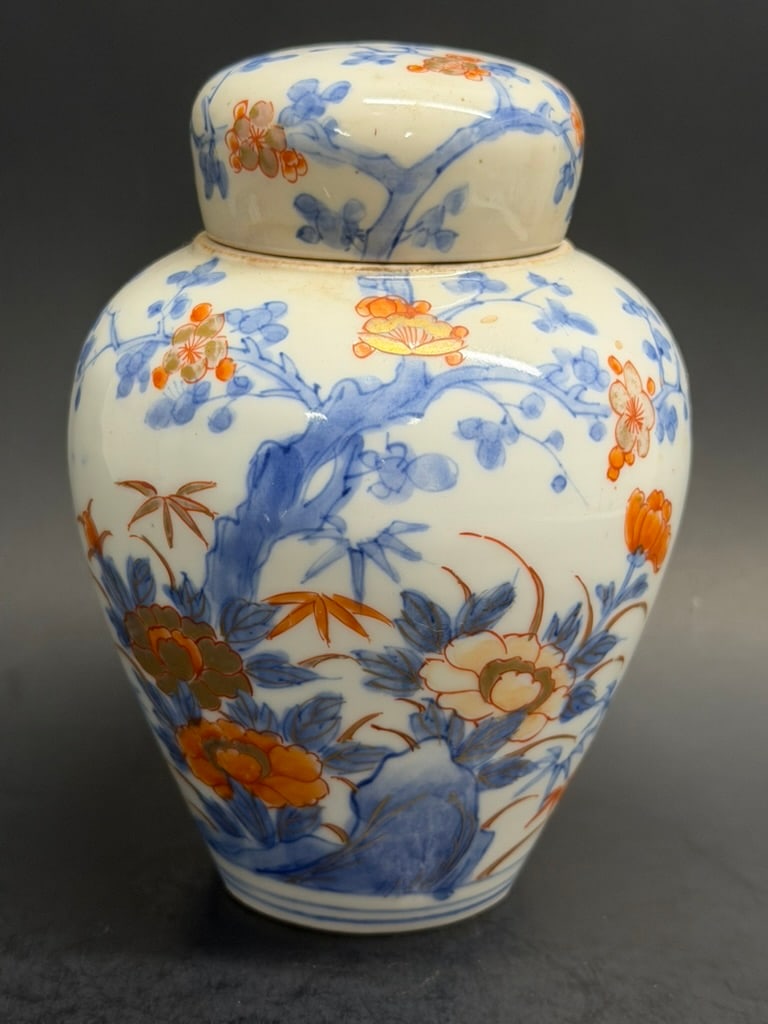 Japanese Early 18th Century Edo Period Imari Ginger Jar: Early 18th Century Japanese Imari Ginger Jar Decorated with blue underglaze prunus trees and other florals/butterflies and red overglaze flowers 5 3/8" tall by 4" wide at shoulder