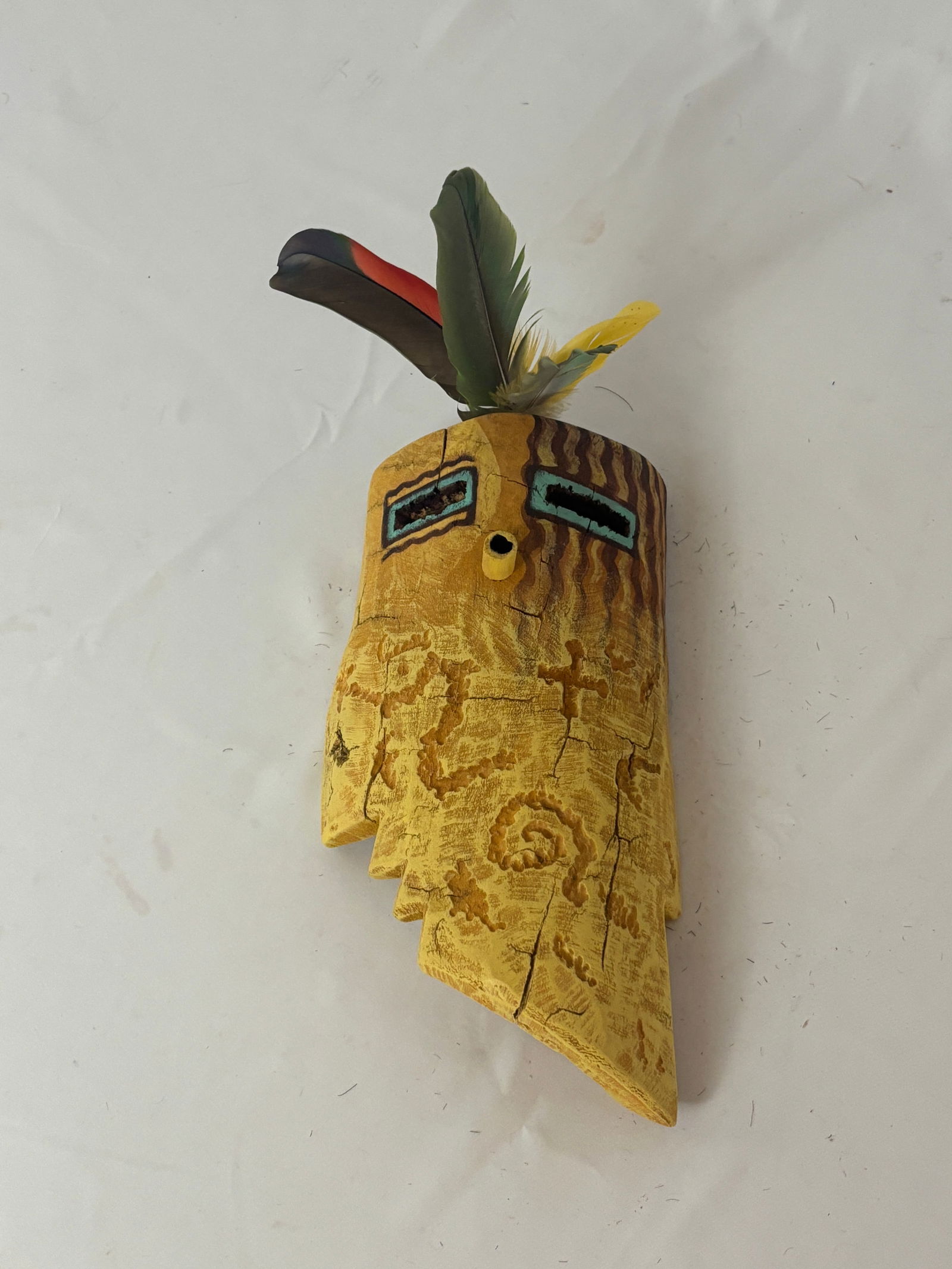 From the South Direction, Peterson Yazzie (b. 1979): Peterson Yazzie (b. 1979)Materials: Wood and feathers; feathers extend an additional 4.5 inches.Peterson Yazzie is a contemporary Navajo artist from Greasewood Springs, AZ. He was born in Fort