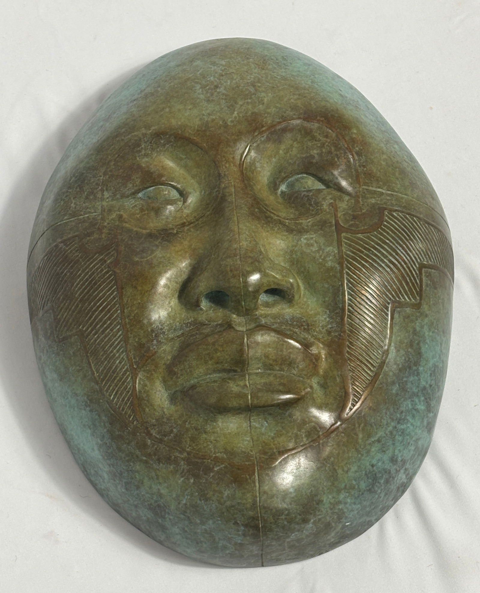 Smithsonian Mask I, 19 of 25, by Roxanne Swentzell: Roxanne Swentzell, b. 1962, Limited-edition bronze casting with a greenish patina. Swentzell’s sculptures often depict figures drawn from Pueblo culture and explore themes of human emotion and