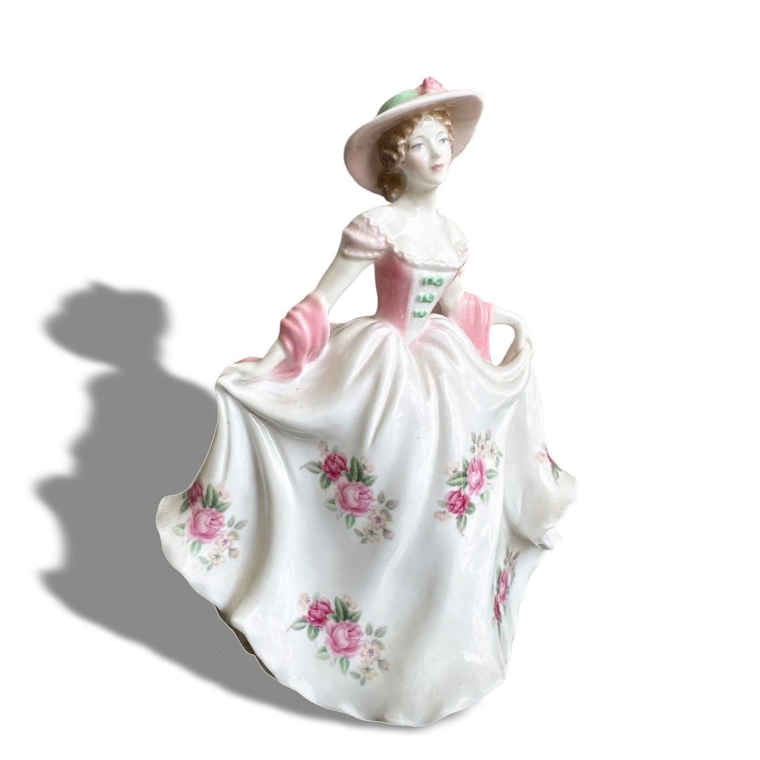 LIMITED EDITION WORCESTER FIGURINE "SWEET ROSE": H: 18 cm (H: 7 1/8 in) This is a limited edition porcelain figurine named "Sweet Rose" by Royal Worcester. The figurine depicts a graceful lady dressed in an elegant gown adorned with delicate pink ro
