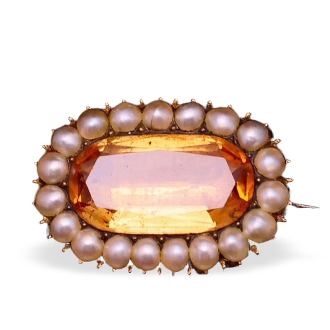 GEORGIAN PERIOD HIGH-KARAT GOLD, TOPAZ, AND NATURAL PEARL BROOCH: Dimensions: 2.54 x 1.66 cm (1 x 5/8 in) Large imperial topaz of exceptional rarity, approx. 6 ct Bezel-set imperial topaz surrounded by a halo of fine natural pearls.