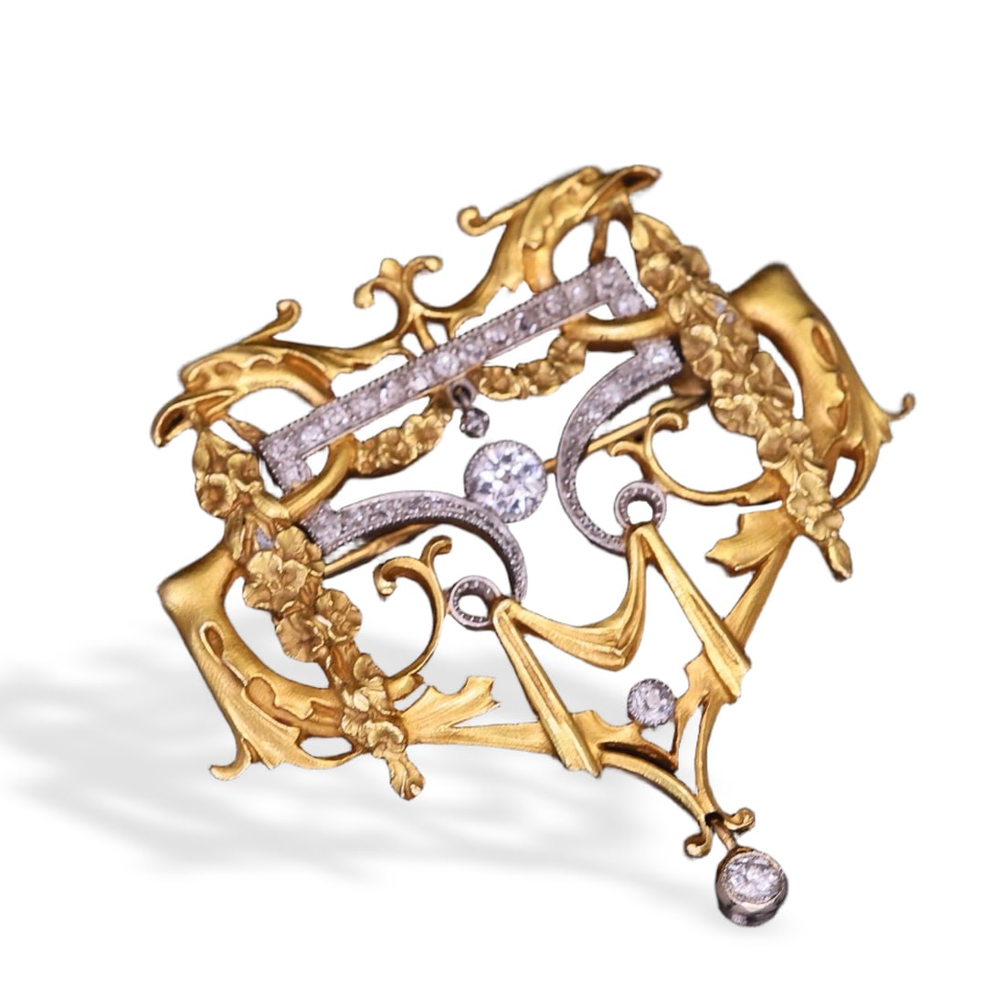 ART NOUVEAU PERIOD 18K GOLD AND PLATINUM SUNBIRD BROOCH: Owl motif piece featuring beaded edges, twin birds, roses, and acanthus scrolls; Greek physician's head hallmark; set with old European cut diamonds; weighs 17.58g.