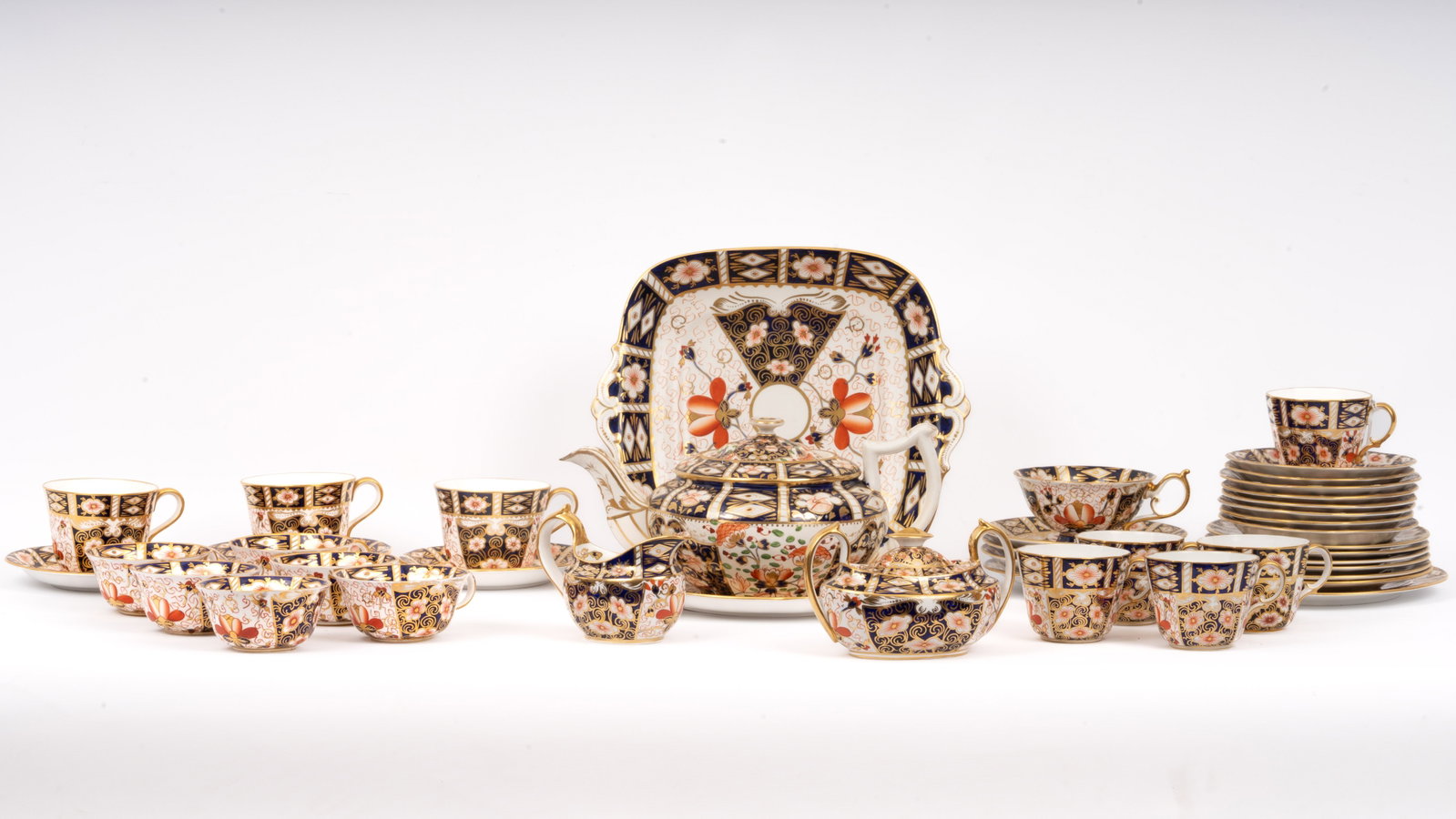 42 Pieces Royal Crown Derby 2451 Imari China Set: 42-piece porcelain tea and coffee service by Royal Crown Derby, showcasing the iconic Imari Pattern 2451. This mixed-form set includes an array of cups, saucers, serving pieces, and teaware, all hand-