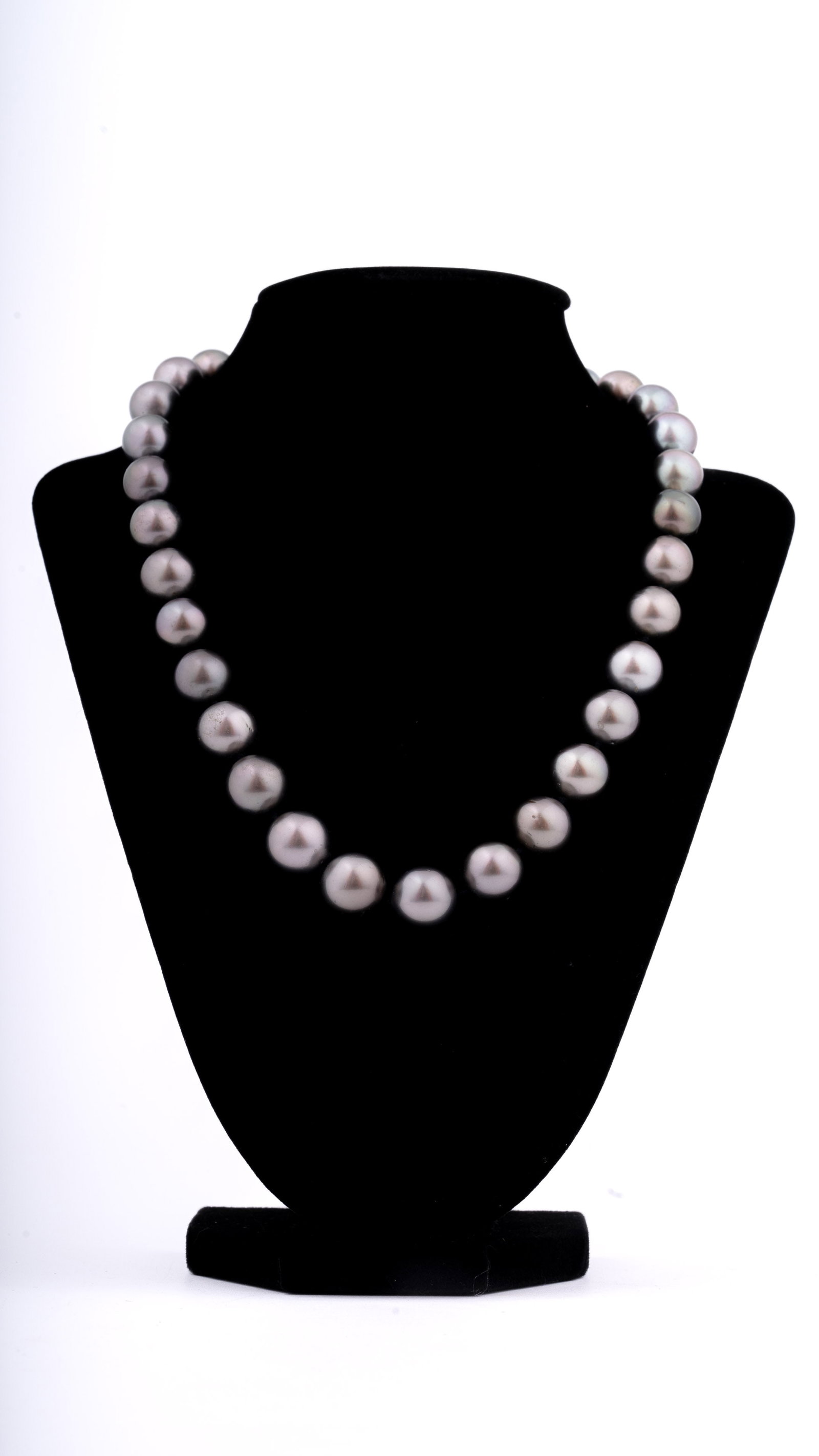 Tahitian Black Pearl Necklace: A refined strand of naturally baroque Tahitian black pearls, displaying a soft gray-lavender overtone with fine luster and subtle iridescence. The pearls are well-matched in shape and hue, strung on s