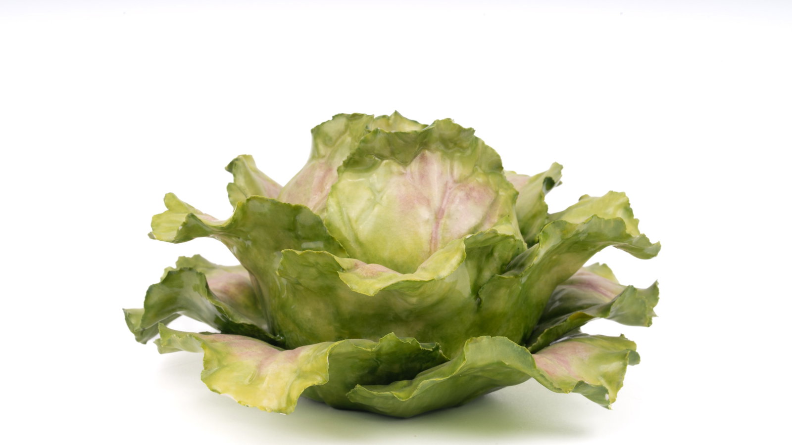 Katherine Houston Porcelain Painted Cabbage: A finely modeled porcelain sculpture by acclaimed American artist Katherine Houston, depicting a lush cabbage rendered in vivid greens with naturalistic violet-tinged highlights. This hand-painted wor