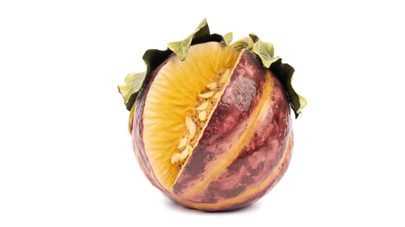 Katherine Houston Porcelain Painted Sliced Pumpkin/Melon: A striking hand-painted porcelain sculpture by renowned artist Katherine Houston, depicting a richly colored pumpkin or melon, split to reveal a finely detailed seed-filled interior. Executed in a bol