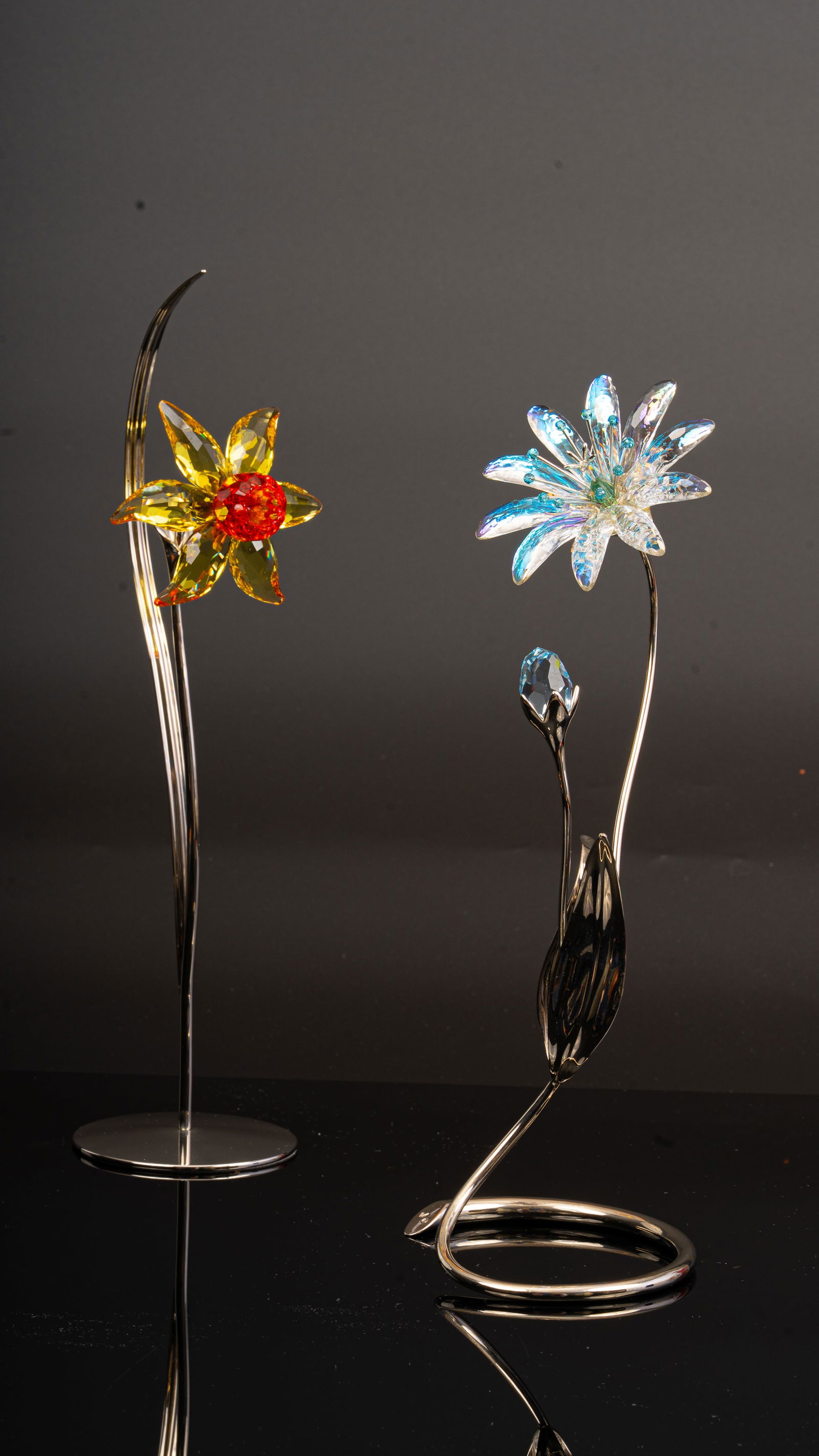 Swarovski Crystal Flowers: Dellaria and Dacali Light Topaz: Two Swarovski crystal floral sculptures comprising the Dellaria Flowers (issued 2008 2012) with tall stem and faceted blossom, and the Paradise Flowers Dacali in Light Topaz designed by Yasmine Hurel