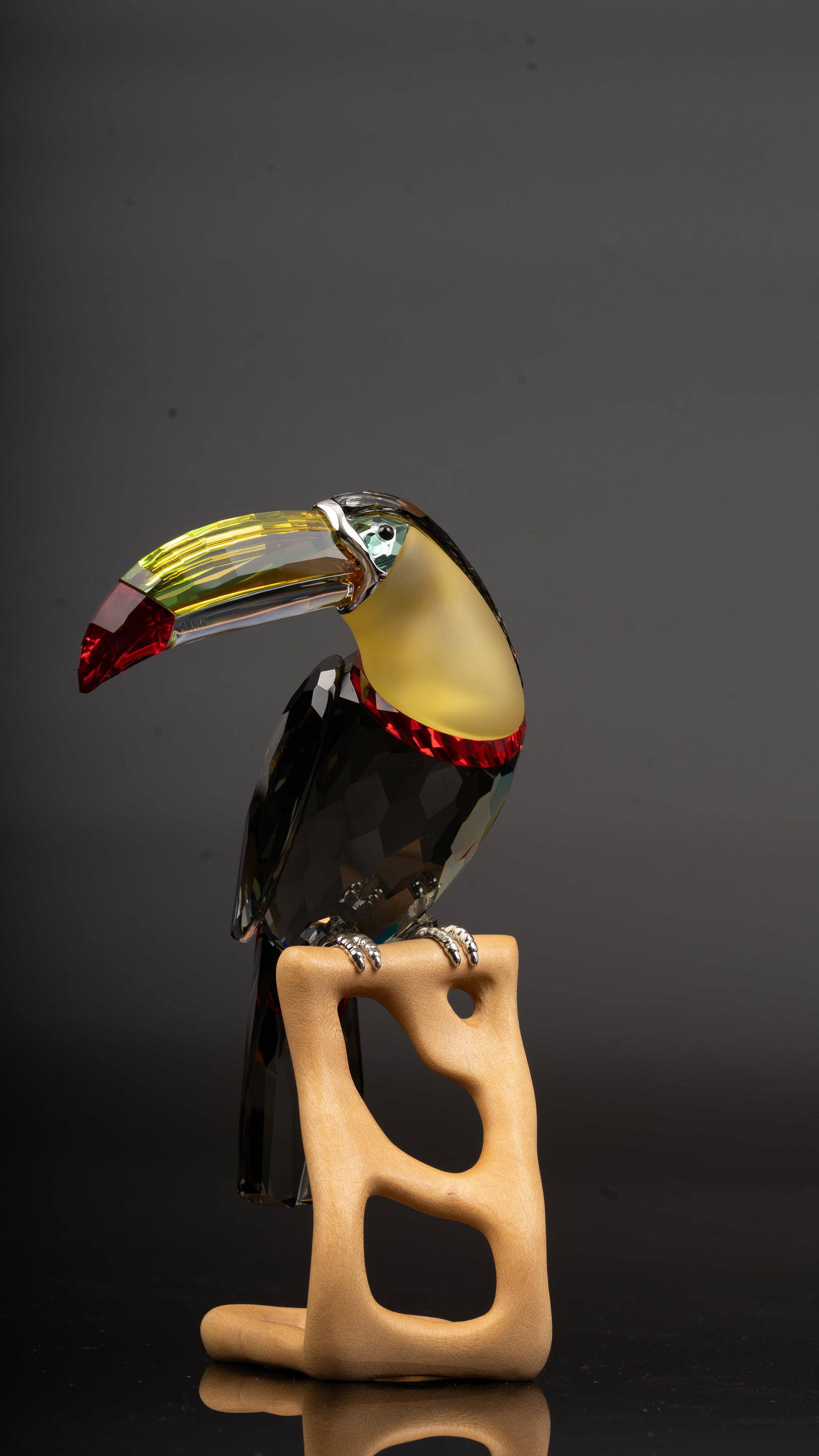 Swarovski Crystal Figurine Black Diamond Toucan – Paradise Bird Collection: A Swarovski crystal figurine from the Paradise Bird Collection, model number #850600, depicting a toucan in faceted Black Diamond crystal, with Erinite crystal eyes, a bill accented in Green Beryll, T