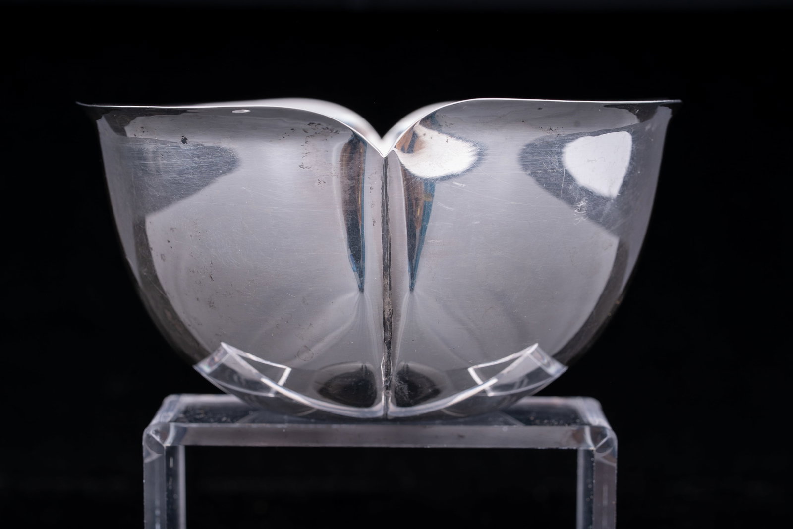 Cartier Sterling Silver Petal-Form Bowl: Elegant mid-century sterling silver bowl by Cartier, Inc., Italy, featuring a sculptural petal-form design with four softly folded lobes radiating from the center. The minimalist, organic shape highli