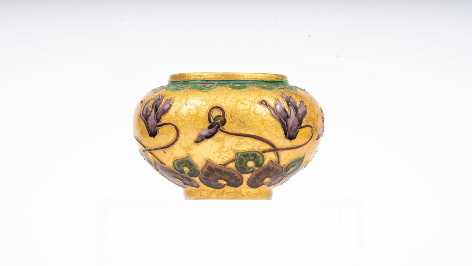 Servres Art Nouveau Gilt and Enamel Pot, Early 20th Century: Sevres porcelain pot of globular form, decorated in relief with stylized morning glories and heart-shaped leaves in purple, green, and brown enamels on a rich gilt ground. The design reflects the sinu