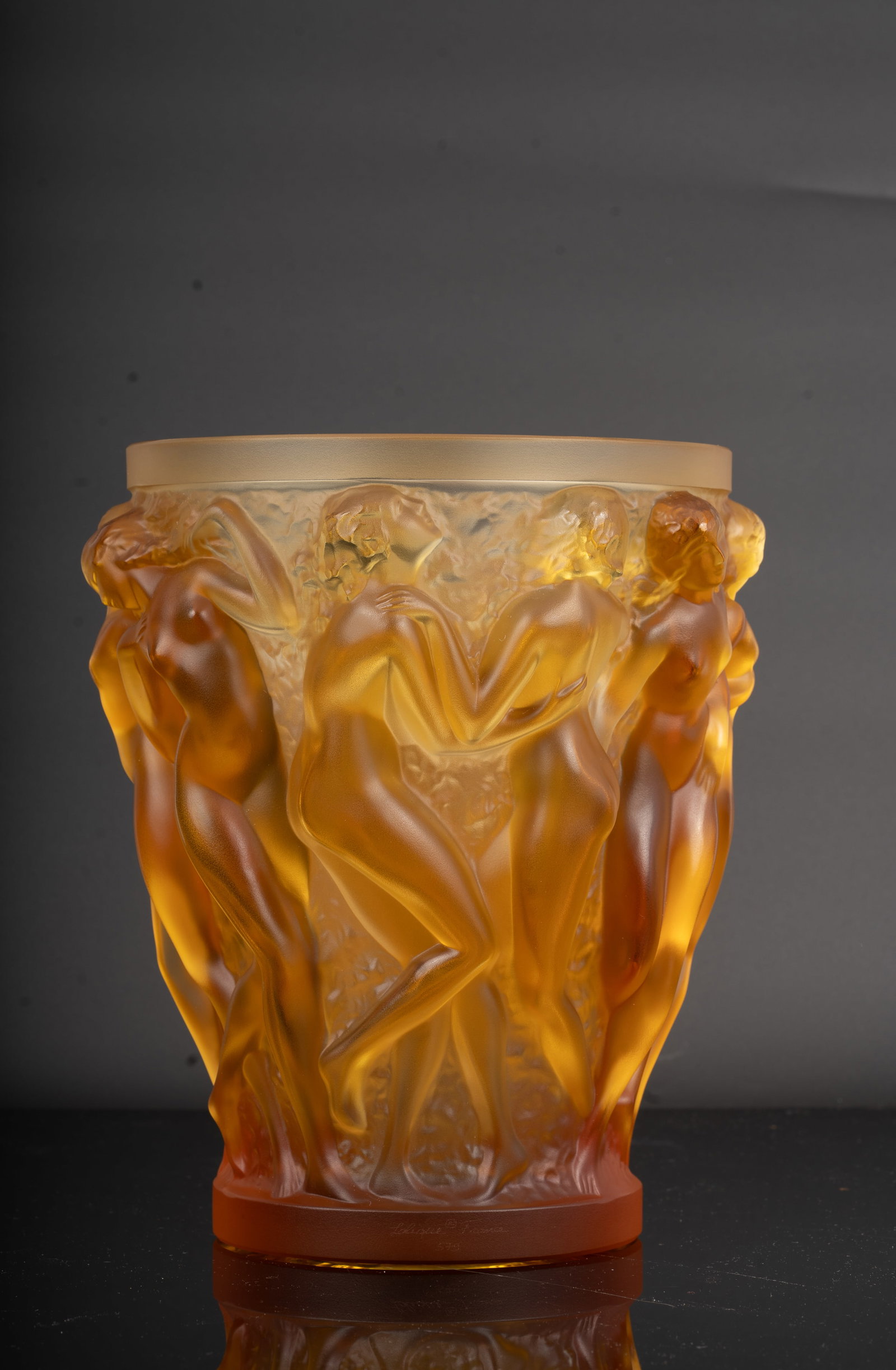 Lalique "Bacchantes" Amber Crystal Vase 80th Anniversary Edition: A striking Lalique France Bacchantes vase in rich amber crystal, celebrating the 80th anniversary of the iconic 1927 design by Rene Lalique. Exquisitely cast with nude female figures in high relief, g