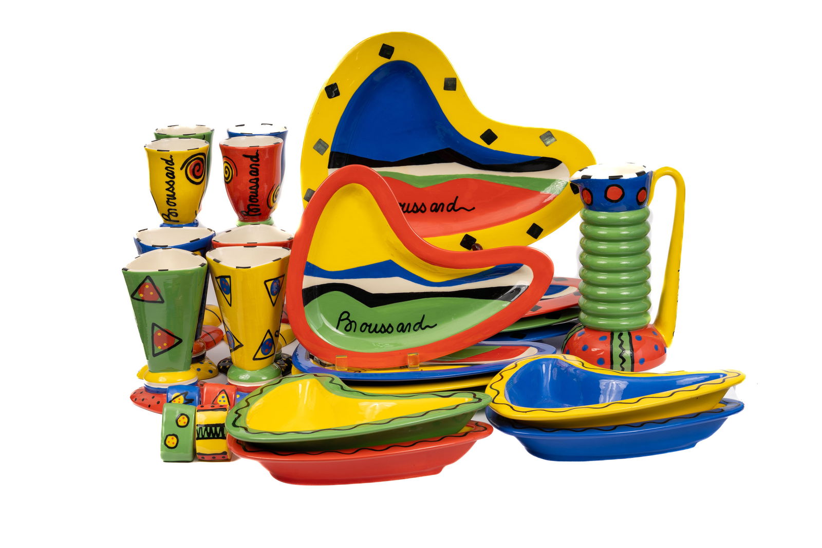 Broussard Mid-Century Hand-Painted Pottery, 25-Piece Collection: An exceptional and vibrant 25-piece pottery set by Broussard, hand-painted in bold primary colors with signature geometric and abstract motifs. The collection includes wine and water goblets, salad an