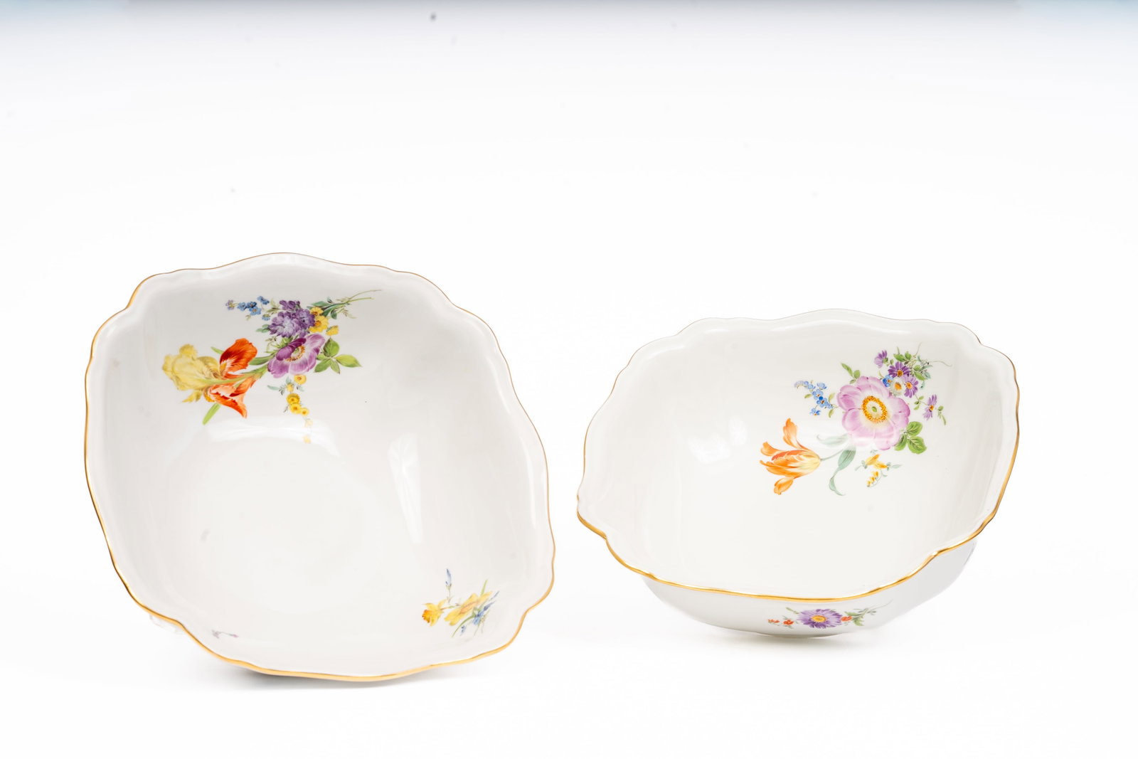 Pair of Meissen Floral Square Serving Bowls: pair of large Meissen porcelain serving bowls, each of scalloped square form with gilt-edged rims and beautifully hand-painted floral sprays. The vivid enamels depict tulips, anemones, and summer blos