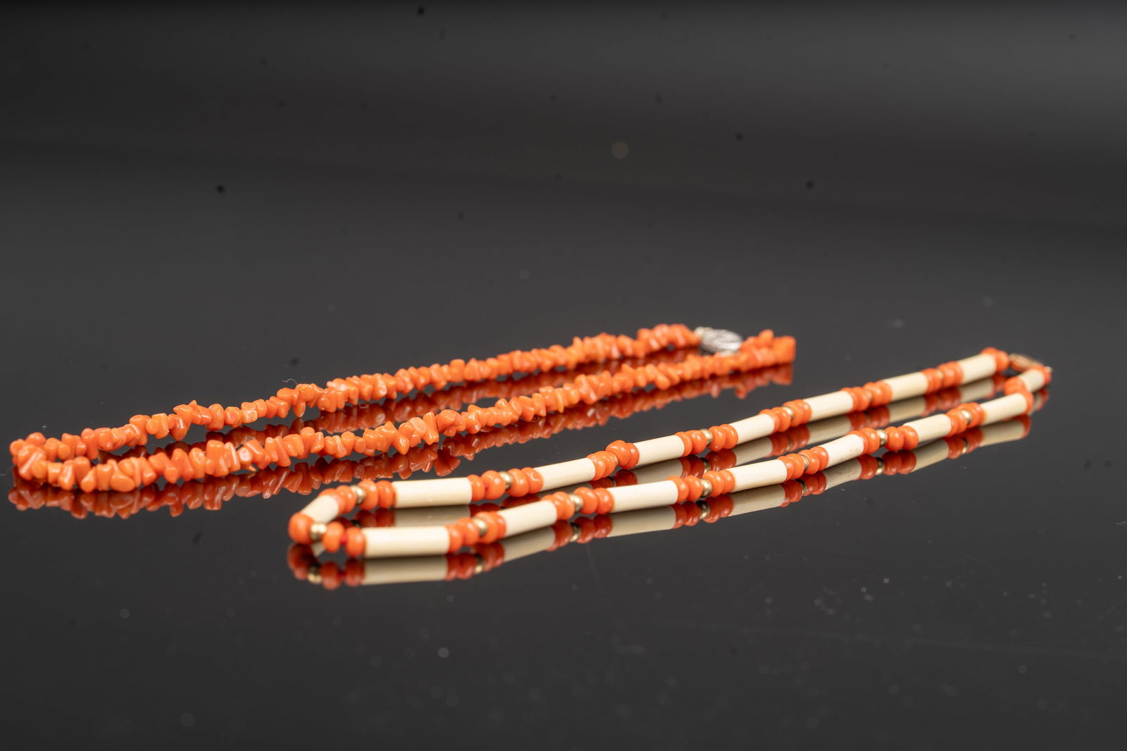 Two Victorian Coral and Bone Necklaces: A pair of 19th-century necklaces composed of natural red coral beads, one strung with irregular branch-form coral beads, the other alternating cylindrical bone and coral beads with yellow and white go