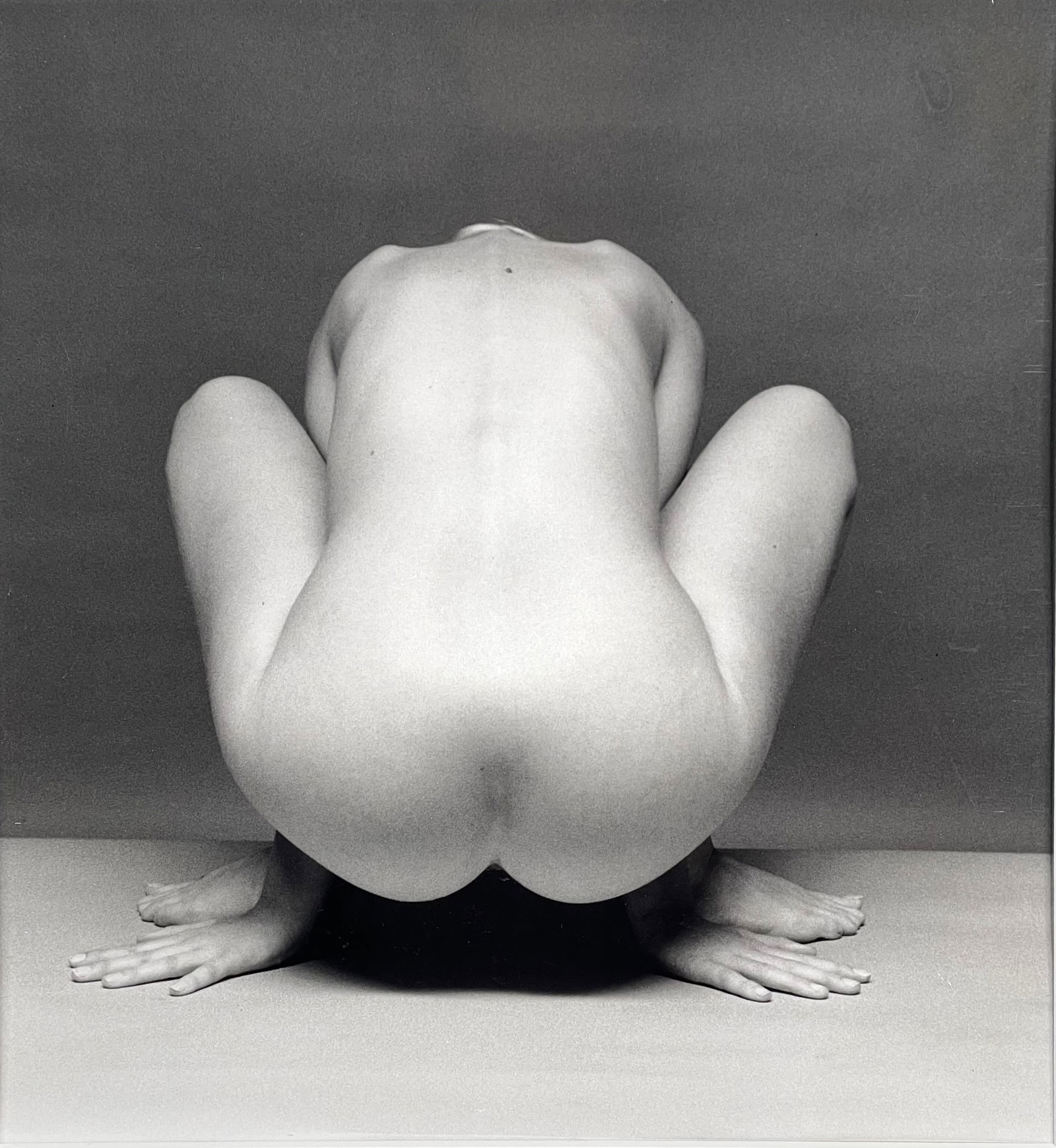 Andre de Dienes (Hungarian, 1913-1985), 1965 (Squatting Nude) SIlver Gelatin Print: Squatting nude sIlver gelatin print by Andre de Dienes. Vintage 1955 print and stamped, vintage nude. Hand stamped on verso. Has slight indentation in print above the model, and some shrinkage in the