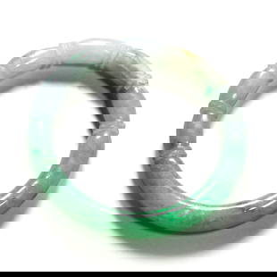 A CHINESE JADEITE BANGLE: A CHINESE JADEITE BANGLE Inner Diameter: 2.4 in. (60 mm)