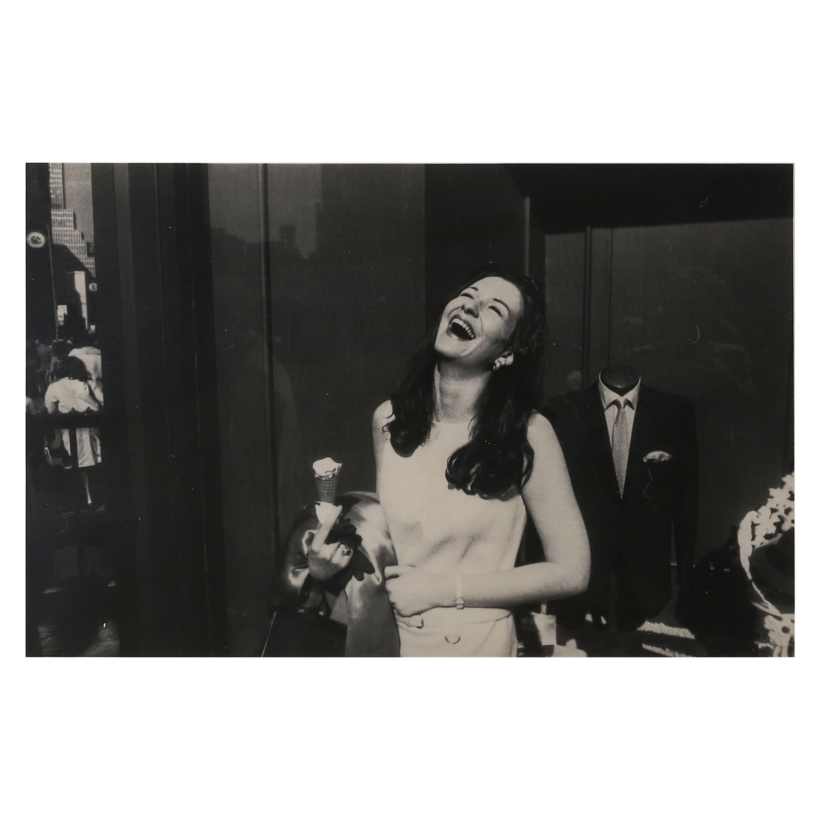 GARRY WINOGRAND (1928-1984) WOMAN WITH ICE CREAM CONE, NEW YORK CITY: Artist GARRY WINOGRAND Title: WOMAN WITH ICE CREAM CONE, NEW YORK CITY Material: Gelatin silver print, mounted on board Signature: Signed “Garry Winogrand” in ink, lower right on the reverse D