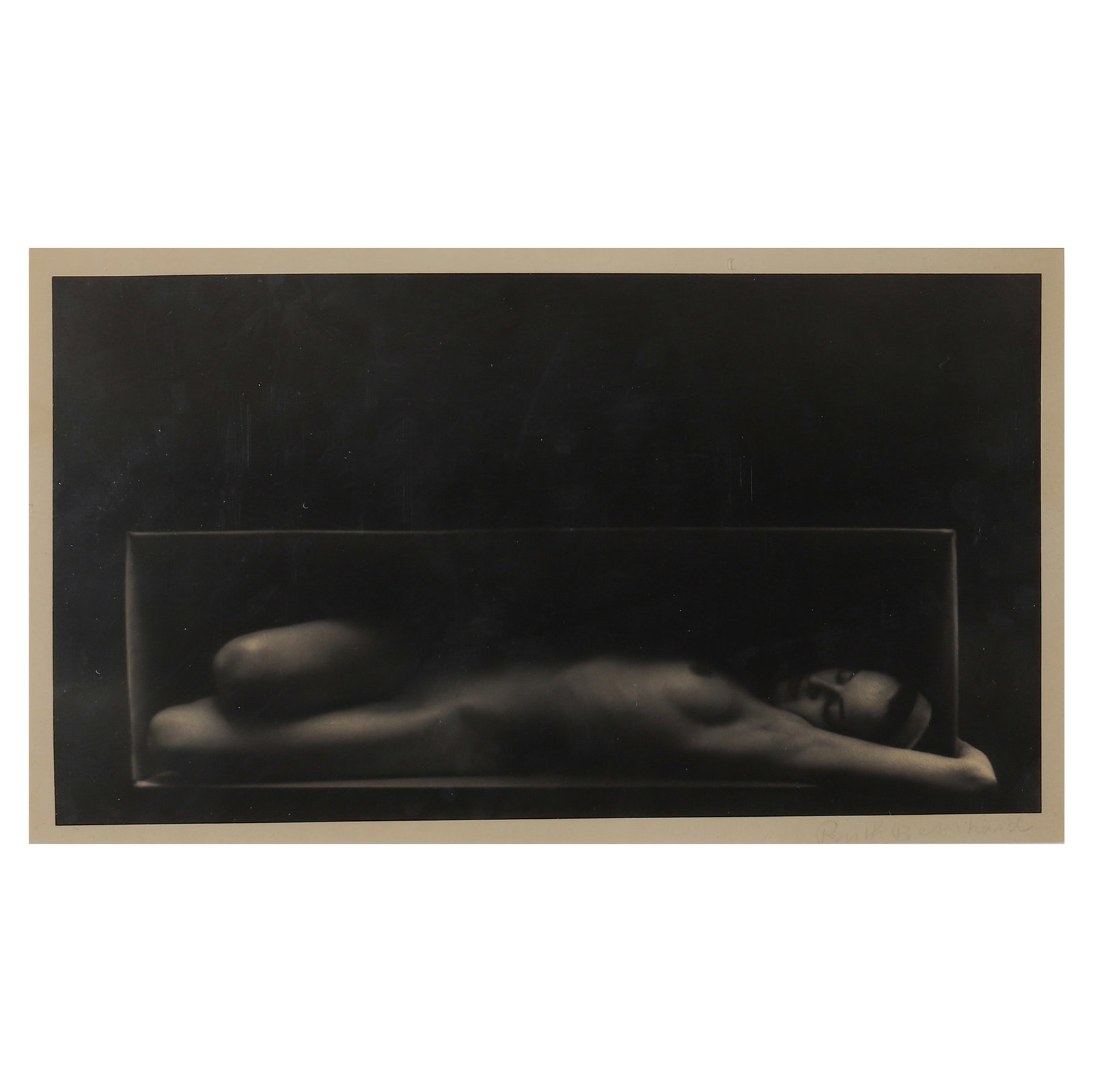 RUTH BERNHARD (1905-2006) NUDE: Artist RUTH BERNHARD Title: IN THE BOX (HORIZONTAL) Material: Gelatin silver print, mounted on board Signature: Signed “Ruth Bernhard,” lower right Dimensions Photograph 7 × 12 5/8 in. (17.7