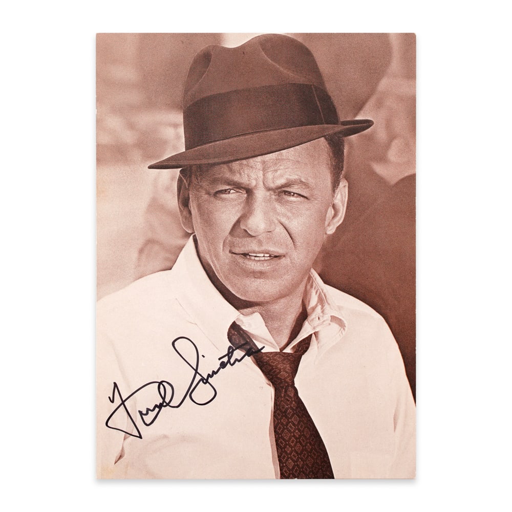 FRANK SINATRA SIGNED POSTCARD: 6 1/8 x 4 3/8 in (15.5 x 11 cm) This signed postcard captures Frank Sinatra at the height of his charisma, presenting the iconic cool confidence that made him one of the most influential entertainers