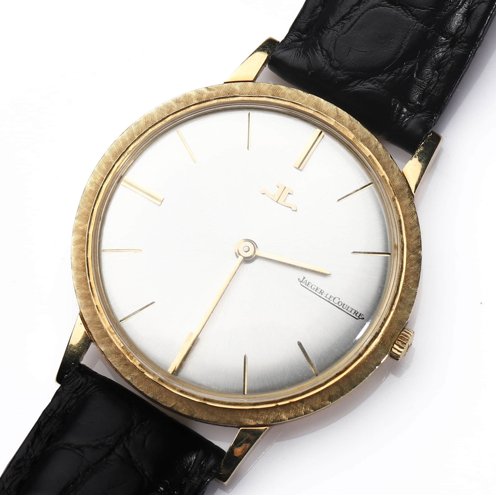 JAEGER-LECOULTRE GOLD WRISTWATCH: Dimensions case diameter 1 5/16 in (33.1 mm); overall length approx. 8 5/8 in (22cm). Description A classic Jaeger-LeCoultre wristwatch featuring a round yellow gold case with a finely textured bezel